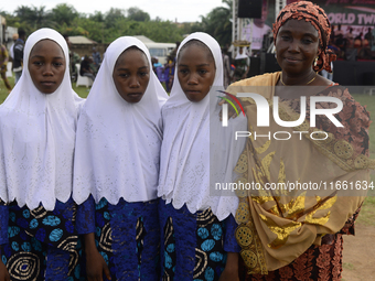 Mrs. Saadat Ismail (R) poses with her triplets, Anida (2nd R), Abiba (2nd L), and Amira, during the 2024 edition of the annual World Twins F...