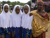 Mrs. Saadat Ismail (R) poses with her triplets, Anida (2nd R), Abiba (2nd L), and Amira, during the 2024 edition of the annual World Twins F...