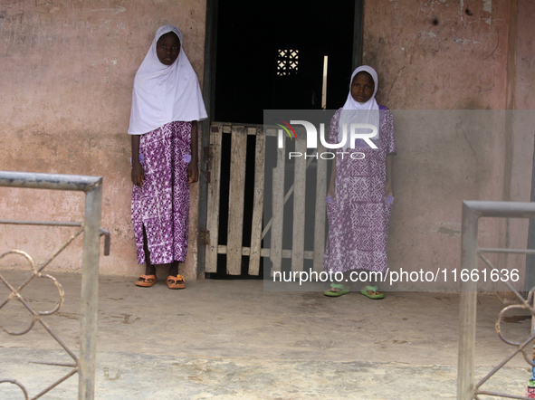 Female twins stand in front of their house during the 2024 edition of the annual World Twins Festival in Igbo-Ora, the Land of Twins, in Oyo...