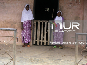 Female twins stand in front of their house during the 2024 edition of the annual World Twins Festival in Igbo-Ora, the Land of Twins, in Oyo...