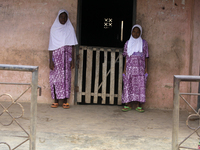 Female twins stand in front of their house during the 2024 edition of the annual World Twins Festival in Igbo-Ora, the Land of Twins, in Oyo...