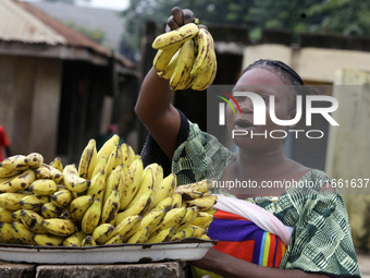 A woman displays bananas for sale during the 2024 edition of the annual World Twins Festival in Igbo-Ora, Oyo State, Nigeria, on October 12,...