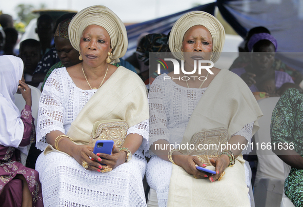 Mrs. Kehinde Oladosu (L) and Mrs. Taiwo Ipadeola, twins, sit during the 2024 edition of the annual World Twins Festival in Igbo-Ora, the Lan...