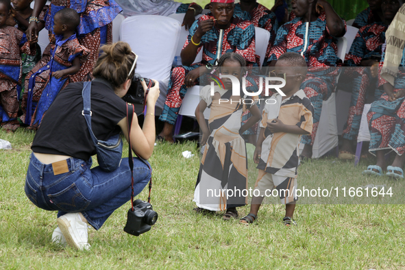 A female photographer photographs twins during the 2024 edition of the annual World Twins Festival in Igbo-Ora, the Land of Twins, in Oyo St...