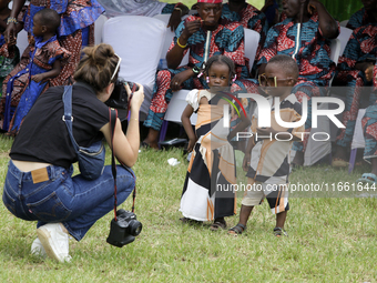 A female photographer photographs twins during the 2024 edition of the annual World Twins Festival in Igbo-Ora, the Land of Twins, in Oyo St...