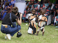 A female photographer photographs twins during the 2024 edition of the annual World Twins Festival in Igbo-Ora, the Land of Twins, in Oyo St...