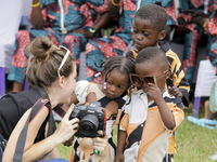 A female photographer displays images of twin children during the 2024 edition of the annual World Twins Festival in Igbo-Ora, the Land of T...