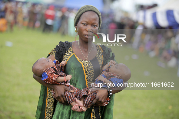 Mrs. Adebola Adeyemo carries newborn twins during the 2024 edition of the annual World Twins Festival in Igbo-Ora, the Land of Twins, in Oyo...