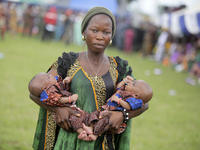 Mrs. Adebola Adeyemo carries newborn twins during the 2024 edition of the annual World Twins Festival in Igbo-Ora, the Land of Twins, in Oyo...