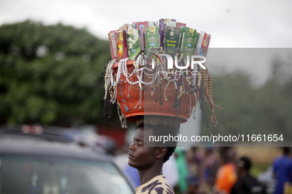 A man hawks Muslim praying beads and other spiritual materials during the 2024 edition of the annual World Twins Festival in Igbo-Ora, the L...