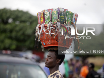 A man hawks Muslim praying beads and other spiritual materials during the 2024 edition of the annual World Twins Festival in Igbo-Ora, the L...