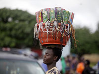 A man hawks Muslim praying beads and other spiritual materials during the 2024 edition of the annual World Twins Festival in Igbo-Ora, the L...