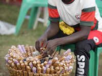 A snacks seller awaits customers during the 2024 edition of the annual World Twins Festival in Igbo-Ora, Nigeria, on October 12, 2024. (