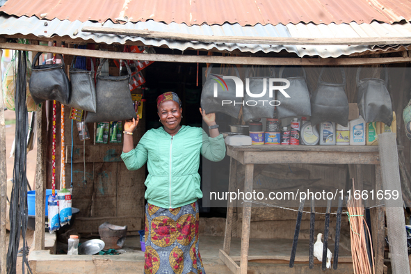 A woman sells household materials in front of her shop during the 2024 edition of the annual World Twins Festival in Igbo-Ora, the Land of T...