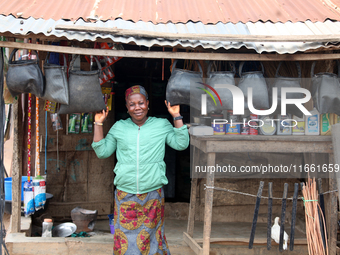 A woman sells household materials in front of her shop during the 2024 edition of the annual World Twins Festival in Igbo-Ora, the Land of T...