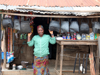 A woman sells household materials in front of her shop during the 2024 edition of the annual World Twins Festival in Igbo-Ora, the Land of T...