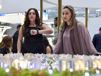 A saleswoman introduces a property to a potential buyer at the Cityscape Qatar 2024 real estate exhibition at the Doha Exhibition and Conven...