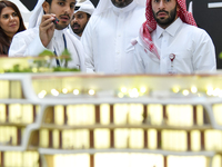 A salesman introduces property to potential buyers at the Cityscape Qatar 2024 real estate exhibition at the Doha Exhibition and Convention...