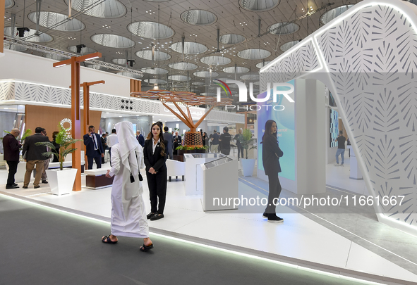 A Qatari visitor walks past a real estate pavilion at the Cityscape Qatar 2024, the real estate exhibition at the Doha Exhibition and Conven...