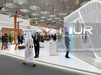 A Qatari visitor walks past a real estate pavilion at the Cityscape Qatar 2024, the real estate exhibition at the Doha Exhibition and Conven...