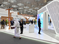 A Qatari visitor walks past a real estate pavilion at the Cityscape Qatar 2024, the real estate exhibition at the Doha Exhibition and Conven...