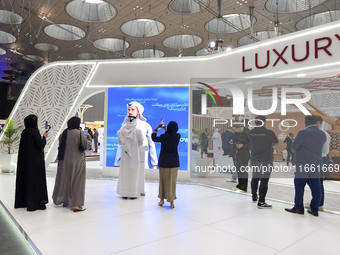 Visitors attend the Cityscape Qatar 2024 real estate exhibition at the Doha Exhibition and Convention Center in Doha, Qatar, on October 13,...