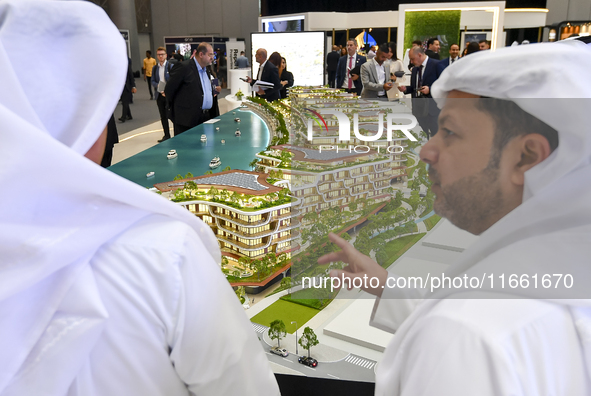 Visitors attend the Cityscape Qatar 2024 real estate exhibition at the Doha Exhibition and Convention Center in Doha, Qatar, on October 13,...