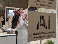 A salesman introduces a property to a potential buyer at the Cityscape Qatar 2024 real estate exhibition at the Doha Exhibition and Conventi...