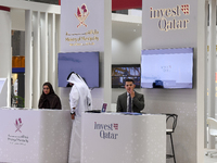 Visitors gather at the Qatar Invest pavilion at the Cityscape Qatar 2024 real estate exhibition at the Doha Exhibition and Convention Center...