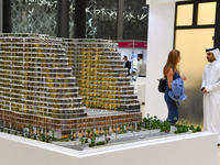 Visitors view models of a new building at the 'Cityscape Qatar 2024' real estate exhibition at the Doha Exhibition and Convention Center in...