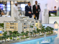 Visitors view models of a new building at the 'Cityscape Qatar 2024' real estate exhibition at the Doha Exhibition and Convention Center in...