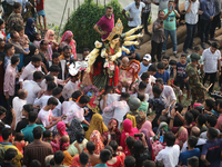 Bangladeshi Hindu devotees carry an idol of the Hindu Goddess Durga to immerse in the Buriganga River during the final day of the Durga Puja...