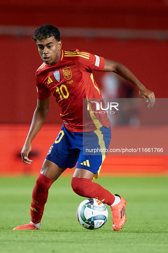 Lamine Yamal of Spain is in action during the UEFA Nations League 2024/25 League A Group A4 game between Spain and Denmark at Enrique Roca S...