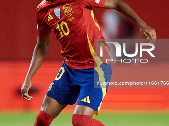 Lamine Yamal of Spain is in action during the UEFA Nations League 2024/25 League A Group A4 game between Spain and Denmark at Enrique Roca S...