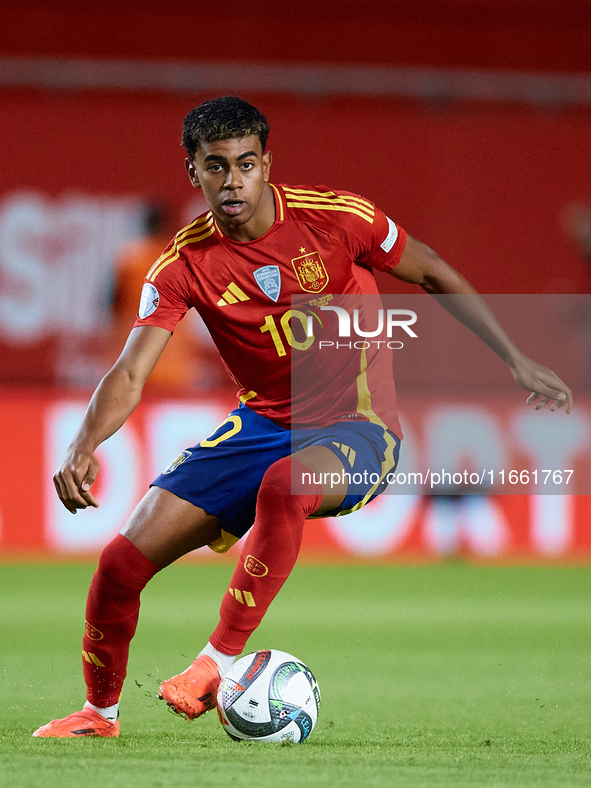 Lamine Yamal of Spain is in action during the UEFA Nations League 2024/25 League A Group A4 game between Spain and Denmark at Enrique Roca S...