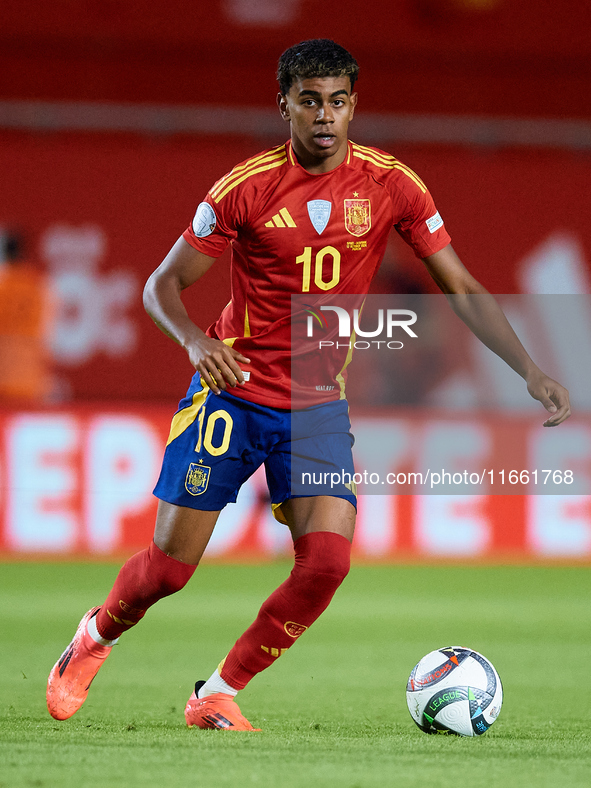 Lamine Yamal of Spain is in action during the UEFA Nations League 2024/25 League A Group A4 game between Spain and Denmark at Enrique Roca S...