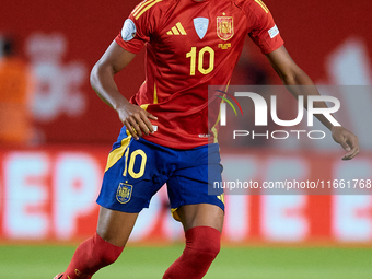 Lamine Yamal of Spain is in action during the UEFA Nations League 2024/25 League A Group A4 game between Spain and Denmark at Enrique Roca S...