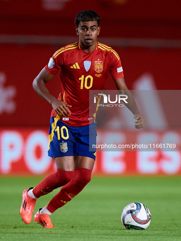 Lamine Yamal of Spain is in action during the UEFA Nations League 2024/25 League A Group A4 game between Spain and Denmark at Enrique Roca S...