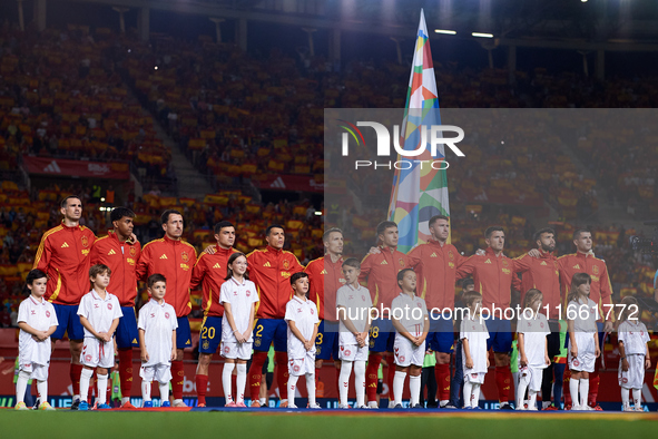 Spain players line up during the national anthems before the UEFA Nations League 2024/25 League A Group A4 game between Spain and Denmark at...