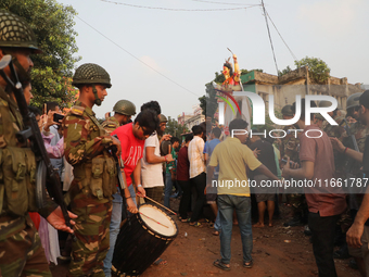 Bangladeshi Hindu devotees carry an idol of the Hindu Goddess Durga to immerse in the Buriganga River during the final day of the Durga Puja...