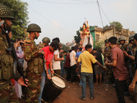 Bangladeshi Hindu devotees carry an idol of the Hindu Goddess Durga to immerse in the Buriganga River during the final day of the Durga Puja...