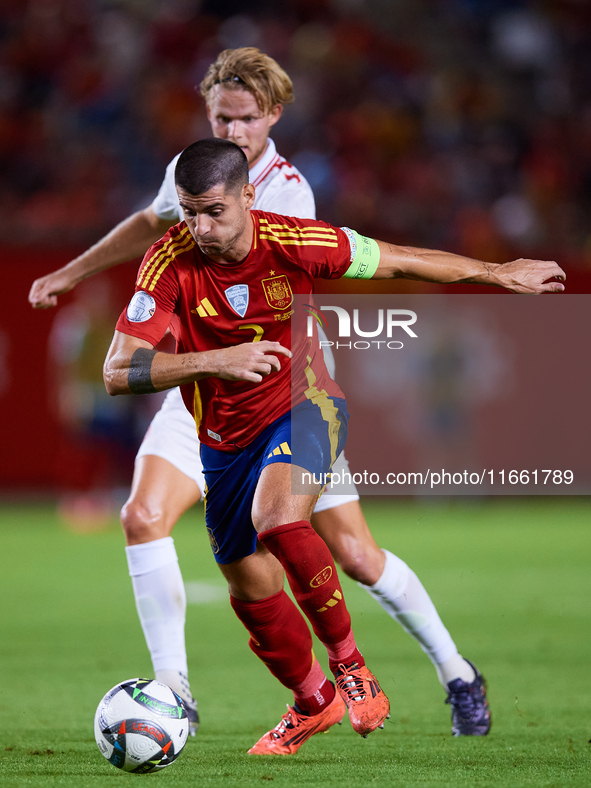 Alvaro Morata of Spain (R) competes for the ball with Hjulmand of Denmark during the UEFA Nations League 2024/25 League A Group A4 game betw...