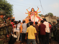 Bangladeshi Hindu devotees carry an idol of the Hindu Goddess Durga to immerse in the Buriganga River during the final day of the Durga Puja...