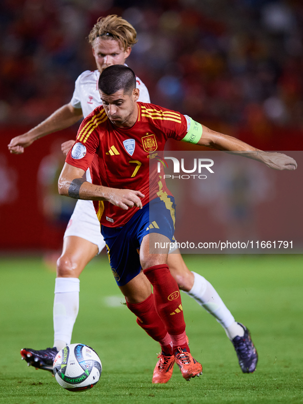 Alvaro Morata of Spain (R) competes for the ball with Hjulmand of Denmark during the UEFA Nations League 2024/25 League A Group A4 game betw...