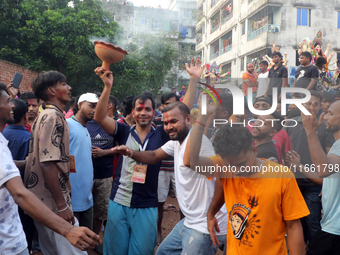 Bangladeshi Hindu devotees carry an idol of the Hindu Goddess Durga to immerse in the Buriganga River during the final day of the Durga Puja...