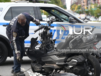 Two people die while riding a motorcycle and crashing into another vehicle in Manhattan, New York, United States, on October 13, 2024. On Su...