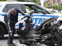 Two people die while riding a motorcycle and crashing into another vehicle in Manhattan, New York, United States, on October 13, 2024. On Su...