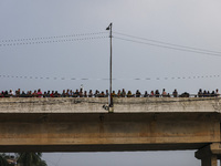 Bangladeshi Hindu devotees immerse an idol of their deity Durga into the Buriganga River during celebrations on the last day of the Durga Pu...