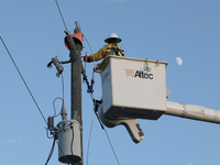 Utility workers supervised by Florida Power and Light work on a transformer in Punta Gorda, Florida, on October 12, 2024. Hurricane Milton m...