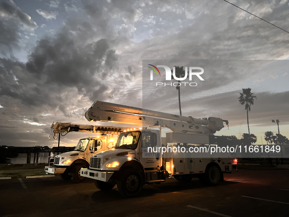 Utility workers supervised by Florida Power and Light work until sunset in Punta Gorda, Florida, on October 12, 2024. Hurricane Milton makes...